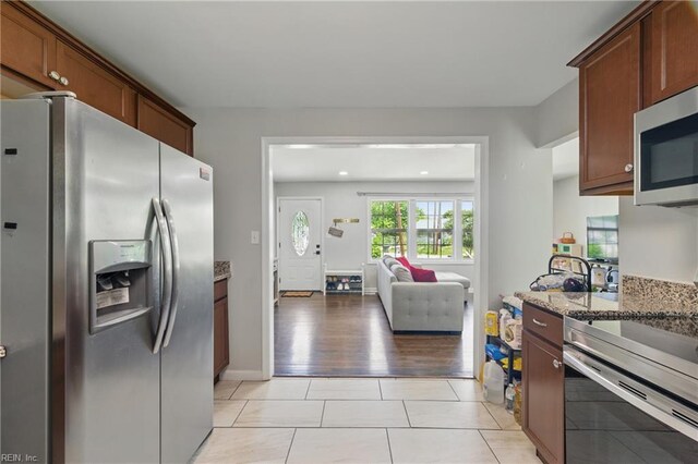 23 Stonewall Ter, Hampton, VA 23666 - kitchen with appliances with stainless steel finishes, light stone counters, open floor plan, light tile patterned floors, and recessed lighting