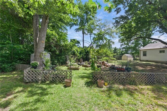 23 Stonewall Ter, Hampton, VA 23666 - view of yard featuring a vegetable garden and an outdoor structure