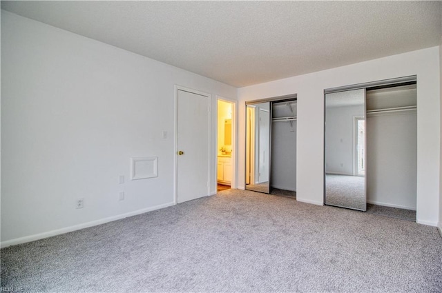 2574 Cove Point Pl, Virginia Beach, VA 23454 - unfurnished bedroom with multiple closets, carpet flooring, baseboards, and a textured ceiling