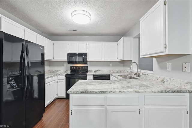 5101 Glenwood Way, Virginia Beach, VA 23456 - kitchen featuring black appliances, a sink, dark wood-type flooring, light stone counters, and white cabinets