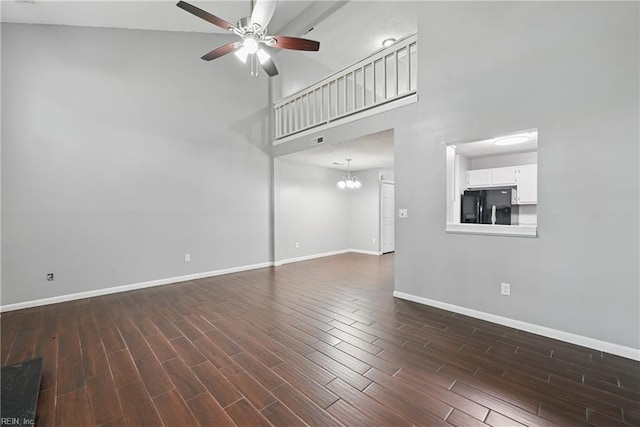 5101 Glenwood Way, Virginia Beach, VA 23456 - unfurnished living room with a ceiling fan, a towering ceiling, baseboards, dark wood-style floors, and a chandelier