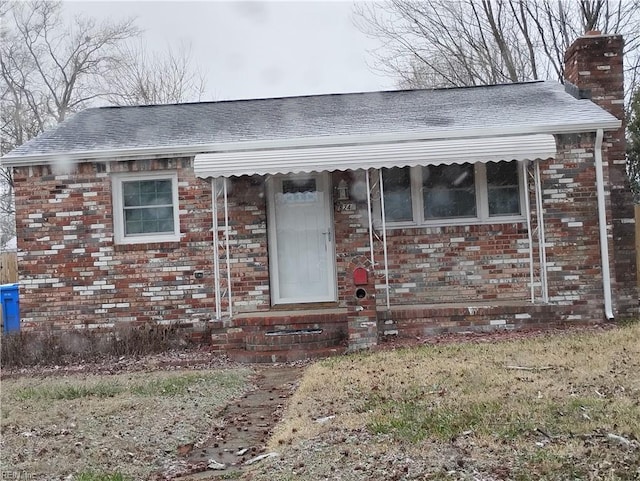 624 Crystal Ave, Chesapeake, VA 23324 - view of front facade with a chimney, brick siding, a shingled roof, and entry steps