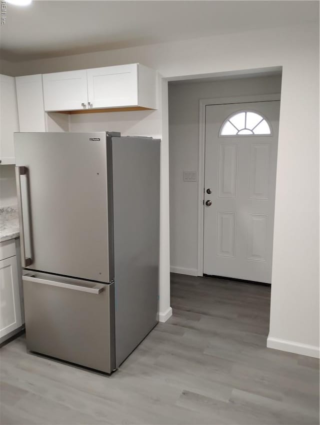 624 Crystal Ave, Chesapeake, VA 23324 - kitchen featuring freestanding refrigerator, white cabinets, baseboards, and light wood-style floors
