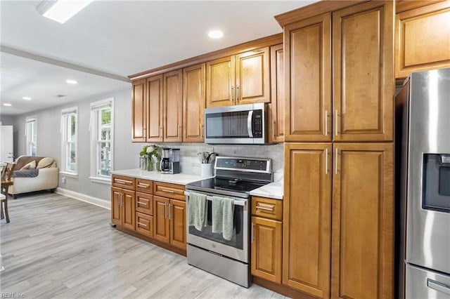 3607 Lafayette Blvd, Norfolk, VA 23513 - kitchen featuring stainless steel appliances, light wood-style floors, brown cabinets, baseboards, and recessed lighting