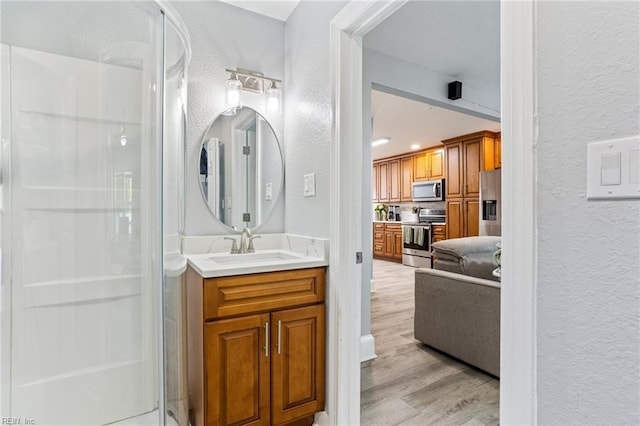 3607 Lafayette Blvd, Norfolk, VA 23513 - full bathroom with a textured wall, a stall shower, vanity, and wood finished floors