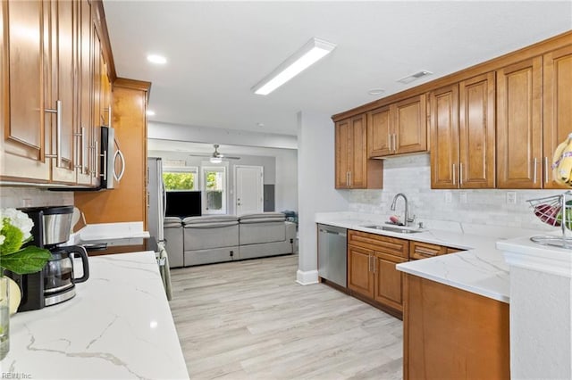 3607 Lafayette Blvd, Norfolk, VA 23513 - kitchen with a sink, appliances with stainless steel finishes, brown cabinets, light stone counters, and recessed lighting