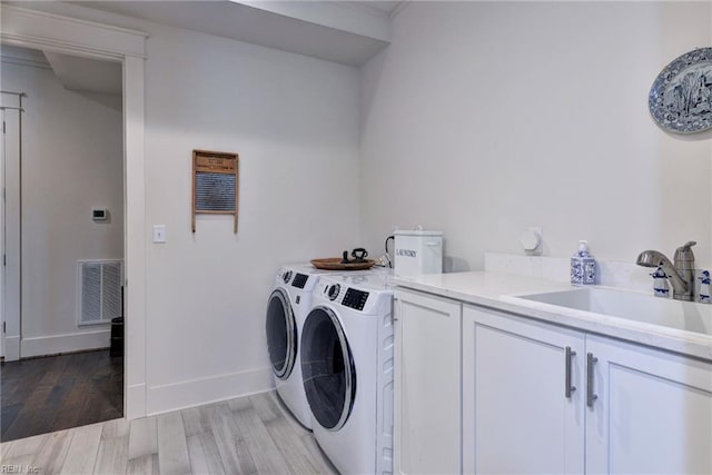 103 Enclave Ct, Williamsburg, VA 23185 - laundry area featuring cabinet space, washer and dryer, light wood-style floors, and baseboards