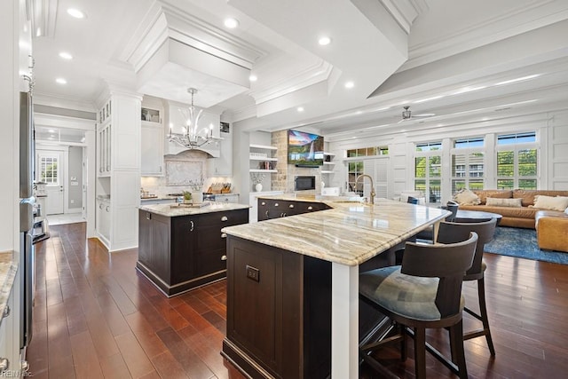 312 Cawdor Xing, Chesapeake, VA 23322 - kitchen featuring a large island with sink, open floor plan, a chandelier, dark wood-style flooring, and ornamental molding