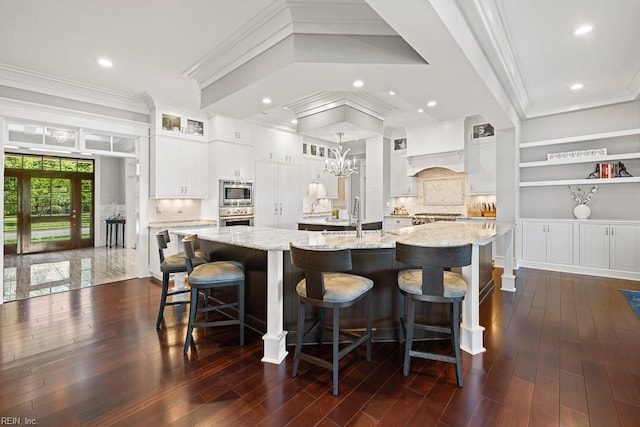 312 Cawdor Xing, Chesapeake, VA 23322 - kitchen with appliances with stainless steel finishes, a large island with sink, a sink, white cabinets, and glass insert cabinets