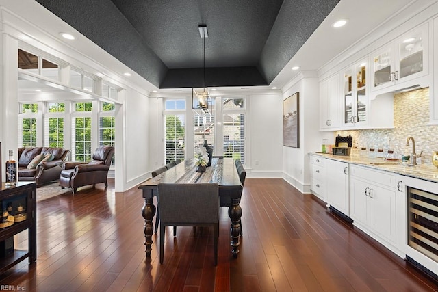 312 Cawdor Xing, Chesapeake, VA 23322 - dining area featuring baseboards, a tray ceiling, wine cooler, dark wood-style flooring, and crown molding