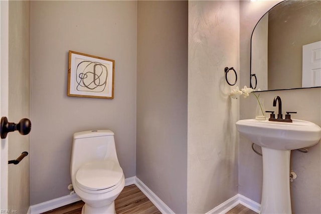 100 Langston Ct, Franklin, VA 23851 - half bath featuring wood finished floors, toilet, baseboards, and a sink