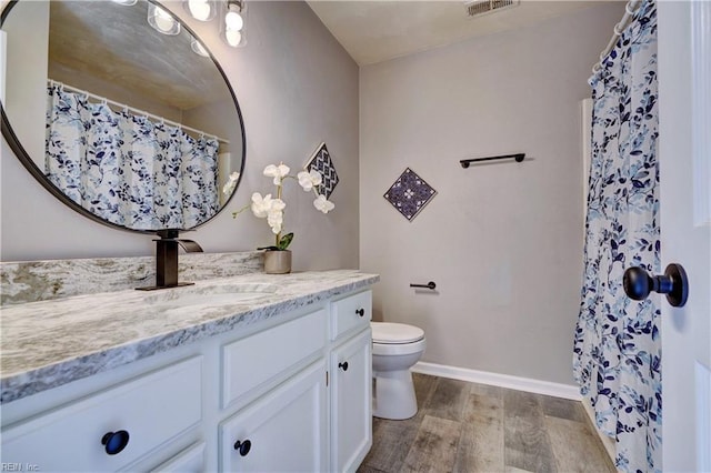 100 Langston Ct, Franklin, VA 23851 - bathroom featuring vanity, wood finished floors, toilet, baseboards, and a shower with shower curtain