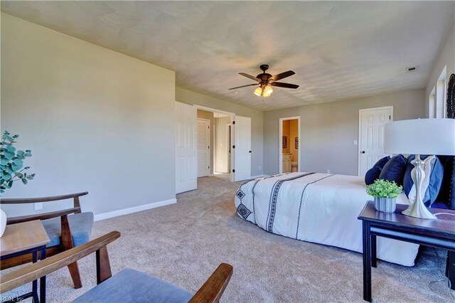 100 Langston Ct, Franklin, VA 23851 - bedroom with baseboards, light colored carpet, ensuite bath, and a ceiling fan