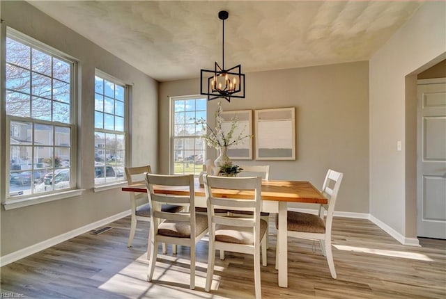 100 Langston Ct, Franklin, VA 23851 - dining space with baseboards, wood finished floors, and a chandelier