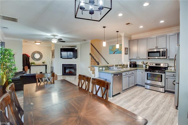 231 Sykes Ave Unit 231, Virginia Beach, VA 23454 - kitchen with appliances with stainless steel finishes, gray cabinets, crown molding, a peninsula, and open floor plan