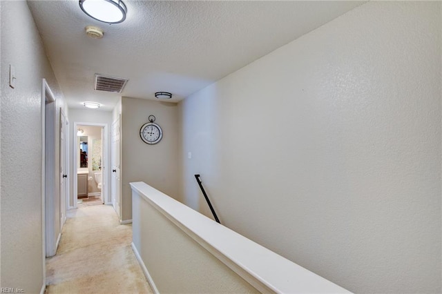 231 Sykes Ave Unit 231, Virginia Beach, VA 23454 - corridor with an upstairs landing, a textured ceiling, baseboards, and light colored carpet