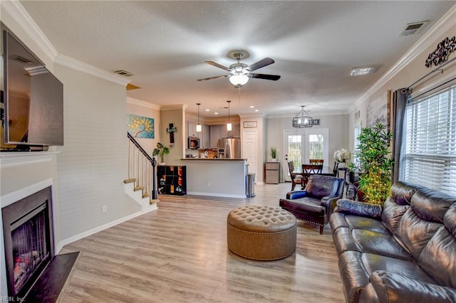231 Sykes Ave Unit 231, Virginia Beach, VA 23454 - living room featuring ceiling fan, stairs, a fireplace with flush hearth, light wood-type flooring, and baseboards