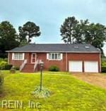 124 Southerland Dr, Hampton, VA 23669 - view of front of home with a garage, driveway, and a front lawn