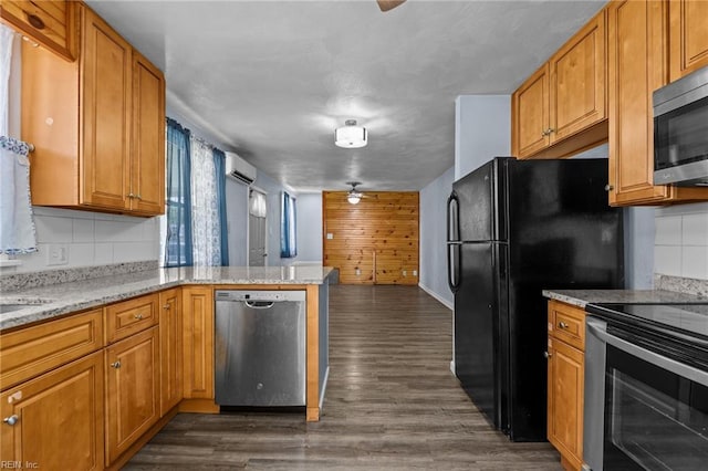 3505 Commonwealth Ave, Portsmouth, VA 23707 - kitchen featuring stainless steel appliances, a wall mounted air conditioner, a peninsula, dark wood-type flooring, and decorative backsplash