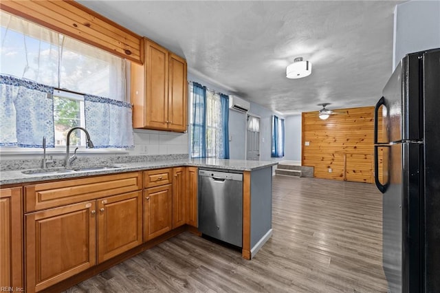 3505 Commonwealth Ave, Portsmouth, VA 23707 - kitchen with dishwasher, freestanding refrigerator, an AC wall unit, a sink, and a peninsula