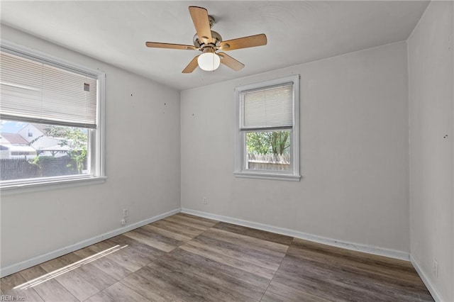 3505 Commonwealth Ave, Portsmouth, VA 23707 - spare room featuring baseboards, a ceiling fan, and wood finished floors