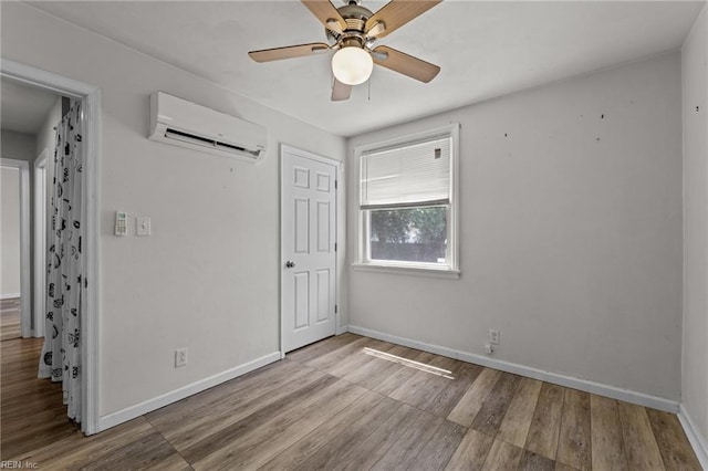 3505 Commonwealth Ave, Portsmouth, VA 23707 - unfurnished bedroom with an AC wall unit, wood finished floors, and baseboards
