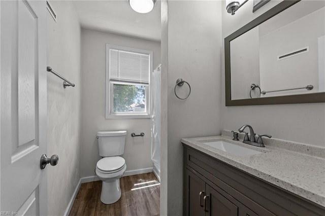 3505 Commonwealth Ave, Portsmouth, VA 23707 - full bath with wood finished floors, vanity, toilet, shower / bath combo with shower curtain, and baseboards