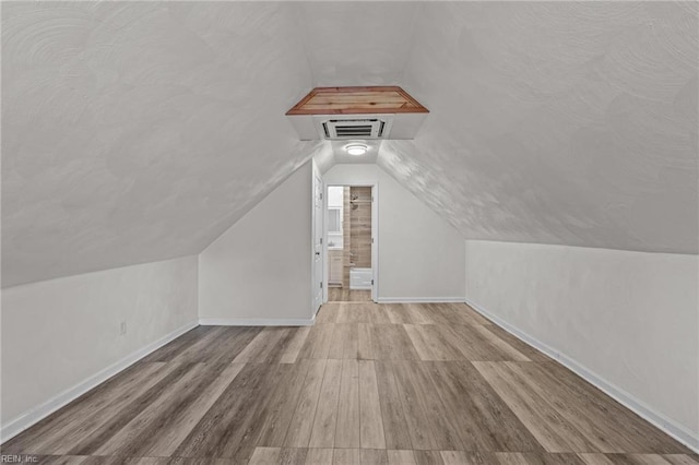 3505 Commonwealth Ave, Portsmouth, VA 23707 - additional living space featuring wood finished floors, vaulted ceiling, and baseboards