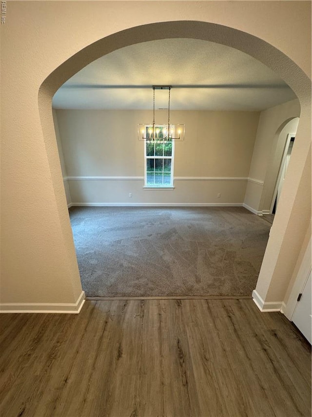 172 Honaker Ave, Norfolk, VA 23502 - unfurnished dining area featuring baseboards, carpet floors, and arched walkways
