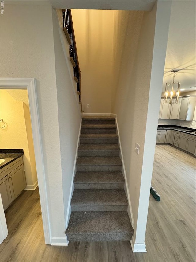 172 Honaker Ave, Norfolk, VA 23502 - stairway featuring baseboards, wood finished floors, and a chandelier