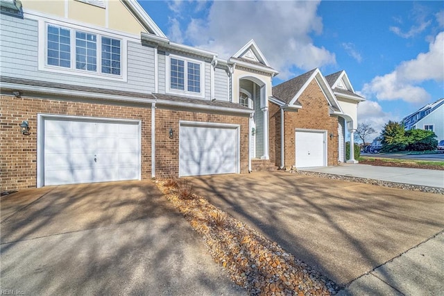 9489 Mooring Dr, Norfolk, VA 23518 - view of front of home with driveway, brick siding, and an attached garage