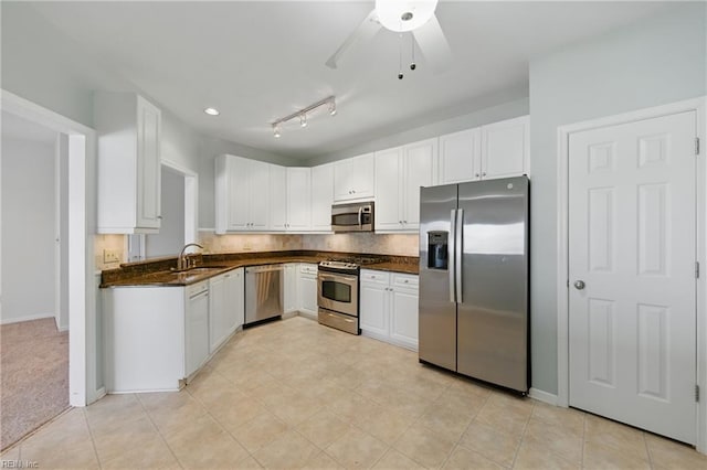 9489 Mooring Dr, Norfolk, VA 23518 - kitchen featuring stainless steel appliances, dark countertops, a sink, and white cabinetry