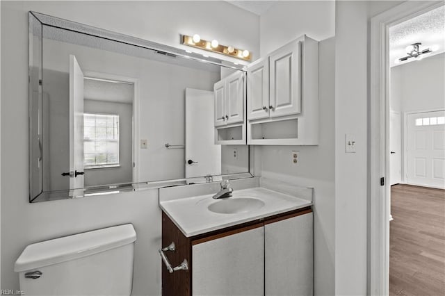 3566 Brigita Ct, Virginia Beach, VA 23453 - half bathroom featuring toilet, vanity, a textured ceiling, and wood finished floors