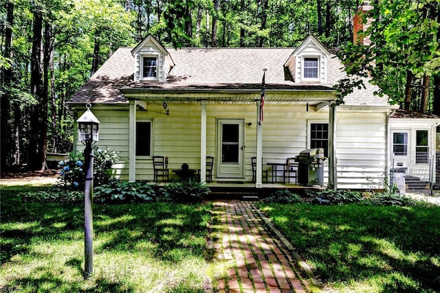 2944 Ridge Rd, Cobbs Creek, VA 23035 - new england style home with a front lawn, a porch, a chimney, and roof with shingles