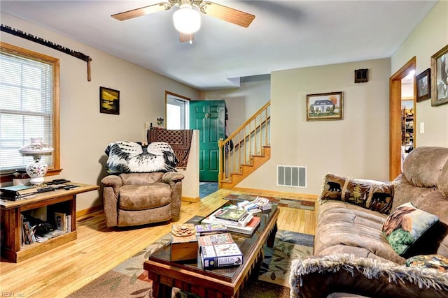 2944 Ridge Rd, Cobbs Creek, VA 23035 - living area with wood finished floors, stairs, a ceiling fan, and baseboards
