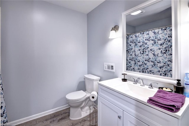 2944 Ridge Rd, Cobbs Creek, VA 23035 - bathroom with toilet, wood finished floors, vanity, and baseboards