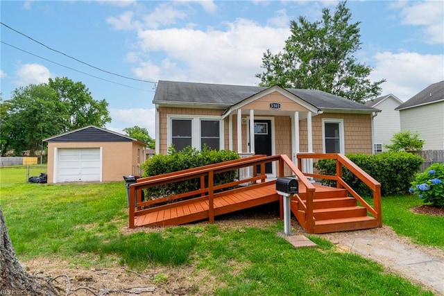 3302 Elliott Ave, Portsmouth, VA 23702 - view of front facade featuring a detached garage, an outbuilding, and roof with shingles