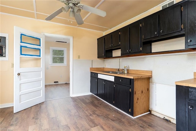3302 Elliott Ave, Portsmouth, VA 23702 - kitchen featuring dark cabinets, ceiling fan, dark wood-style floors, a sink, and light countertops