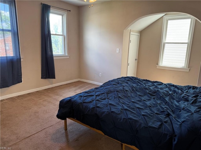 307 W 30th St, Norfolk, VA 23508 - carpeted bedroom featuring arched walkways and baseboards