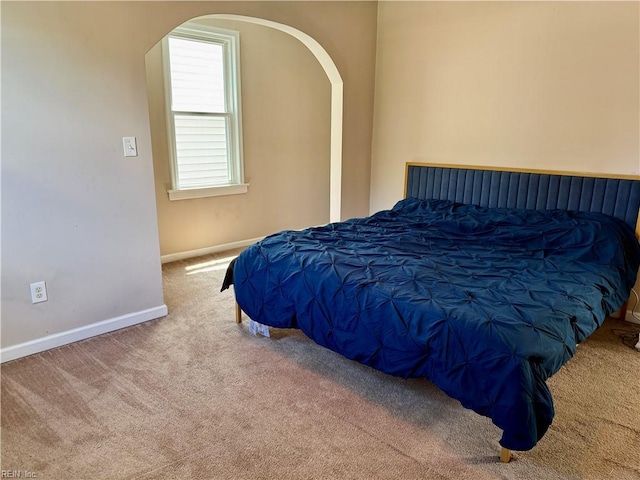 307 W 30th St, Norfolk, VA 23508 - carpeted bedroom featuring arched walkways and baseboards