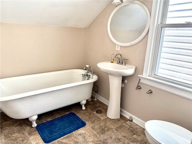 307 W 30th St, Norfolk, VA 23508 - bathroom with toilet, a soaking tub, healthy amount of natural light, and baseboards