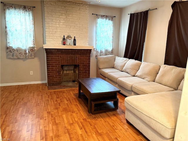 307 W 30th St, Norfolk, VA 23508 - living area with light wood-type flooring, baseboards, and a brick fireplace