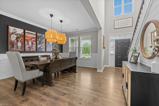 3012 George Starr Dr, Virginia Beach, VA 23456 - dining area featuring crown molding, light wood-style flooring, a textured ceiling, and wainscoting