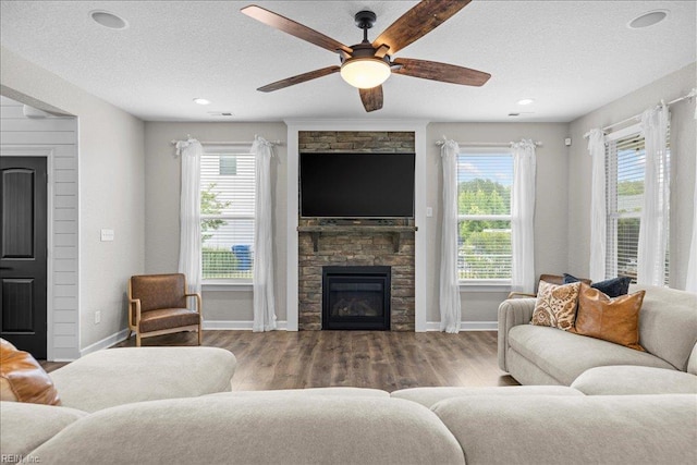 3012 George Starr Dr, Virginia Beach, VA 23456 - living area with a fireplace, healthy amount of natural light, baseboards, a ceiling fan, and a textured ceiling