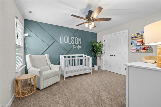 3012 George Starr Dr, Virginia Beach, VA 23456 - bedroom featuring carpet flooring, a crib, a closet, ceiling fan, and a decorative wall
