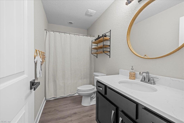 3012 George Starr Dr, Virginia Beach, VA 23456 - bathroom featuring vanity, toilet, a textured ceiling, wood finished floors, and a shower with curtain