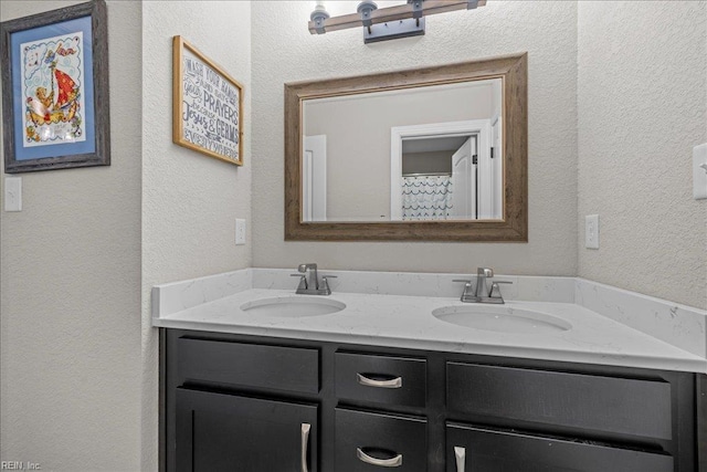 3012 George Starr Dr, Virginia Beach, VA 23456 - full bathroom with double vanity and a textured wall