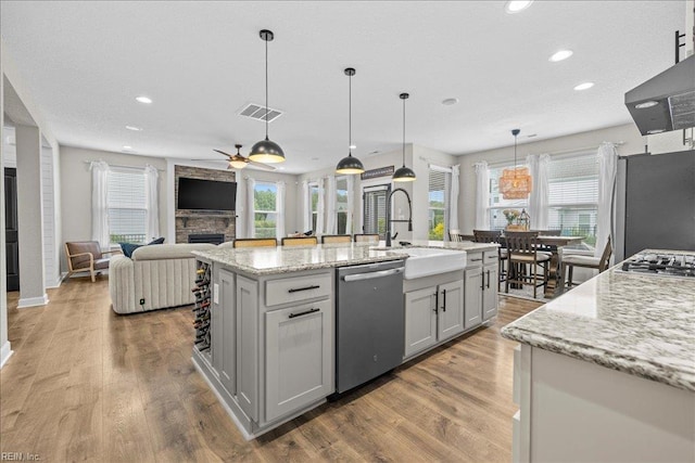 3012 George Starr Dr, Virginia Beach, VA 23456 - kitchen with appliances with stainless steel finishes, a sink, a ceiling fan, a stone fireplace, and recessed lighting