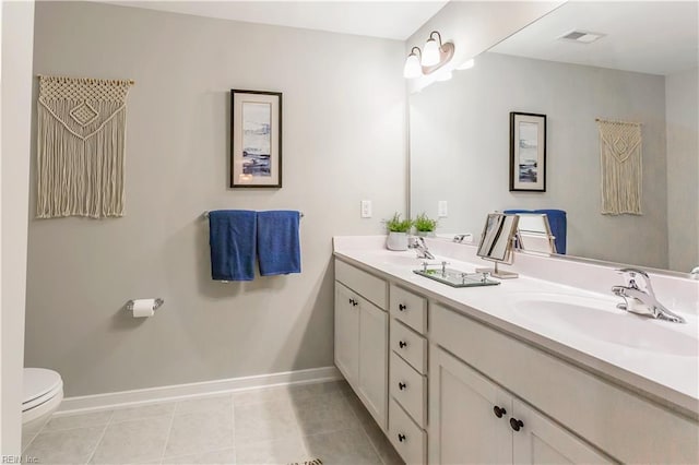 123 Getty Rd, Suffolk, VA 23434 - bathroom featuring baseboards, double vanity, toilet, and tile patterned flooring
