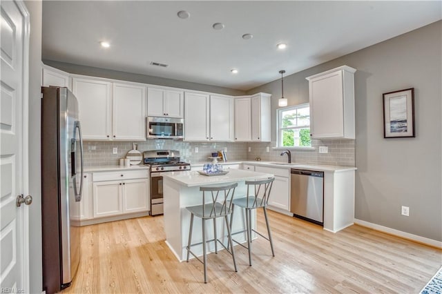 123 Getty Rd, Suffolk, VA 23434 - kitchen with appliances with stainless steel finishes, light wood-style floors, a sink, white cabinetry, and light countertops